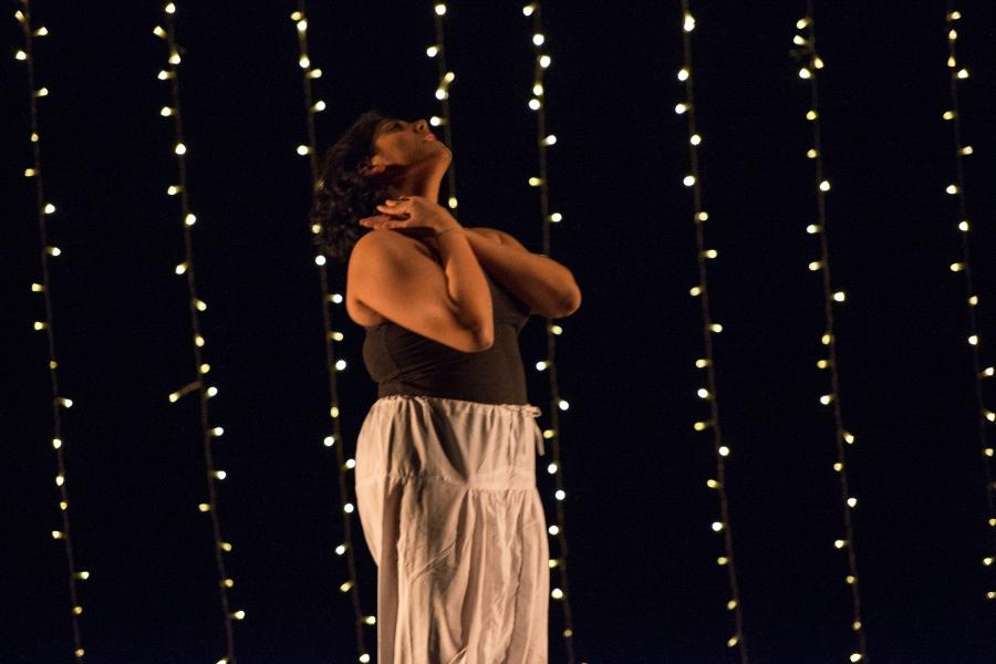 woman standing still against backdrop of lights